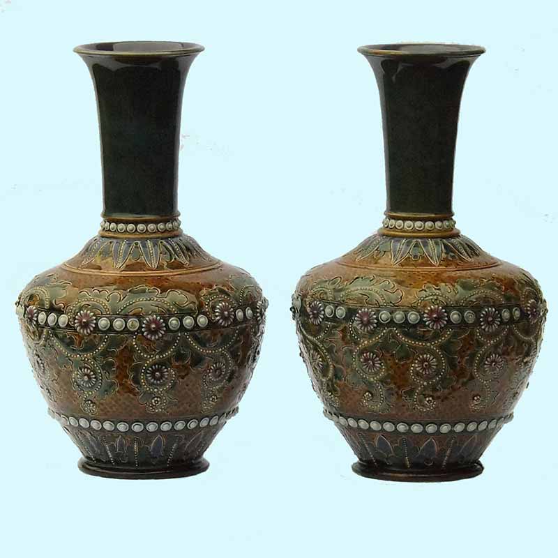 George Tinworth - a pair of 10in (25cm) Doulton Lambeth vases.